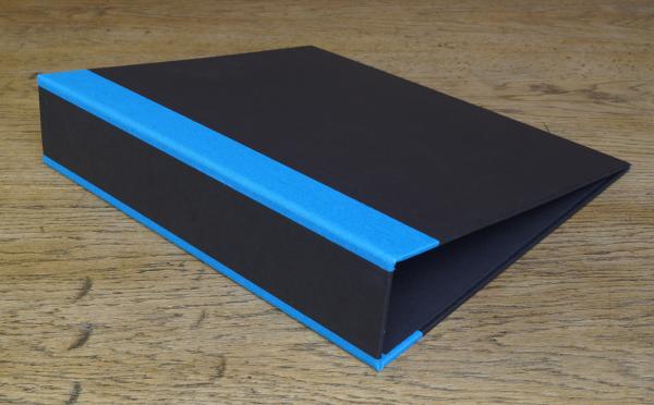 black folder with linen-reinforced edges in bright blue